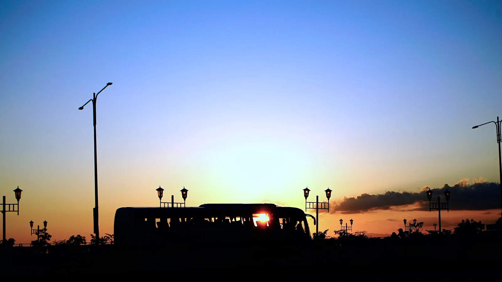 A bus on a street at sunset in Iloilo City