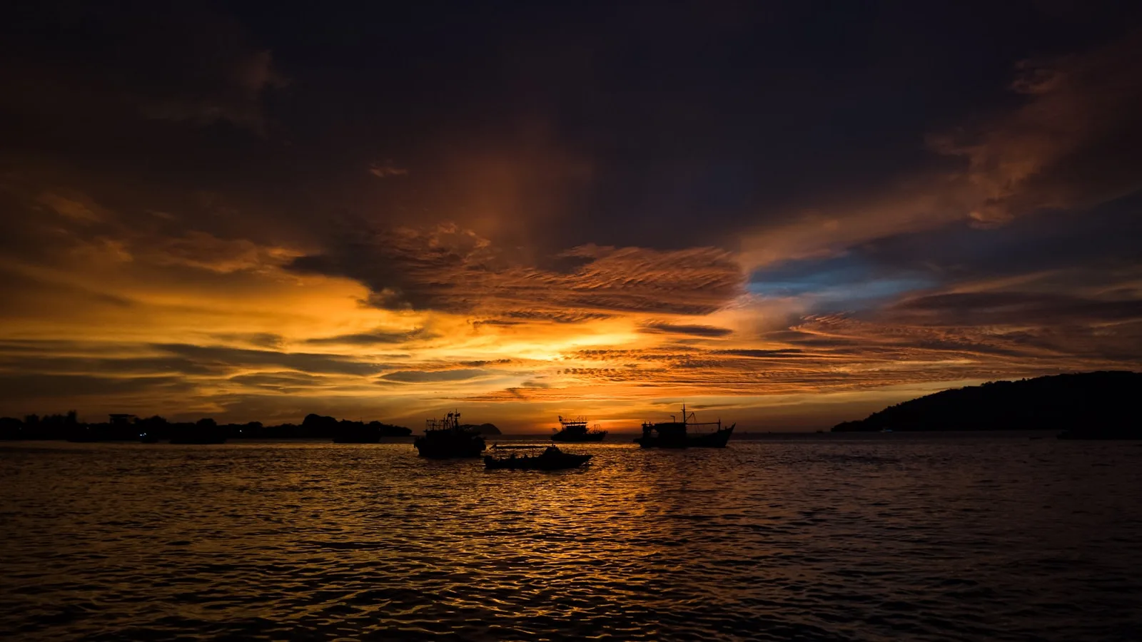 A sunset over water in Kota Kinabalu