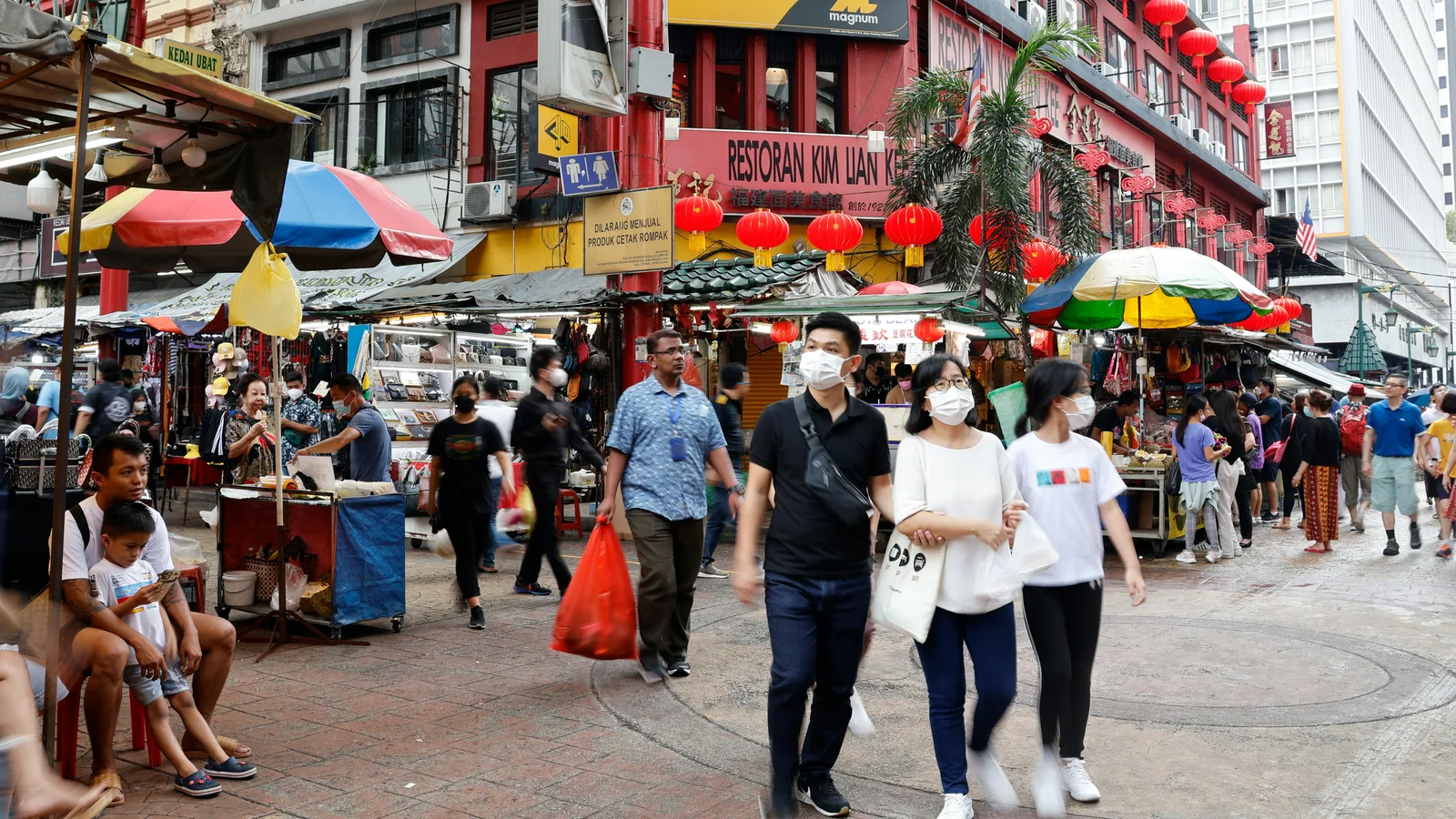 Pedestrians at a street market in Kuala Lumpur