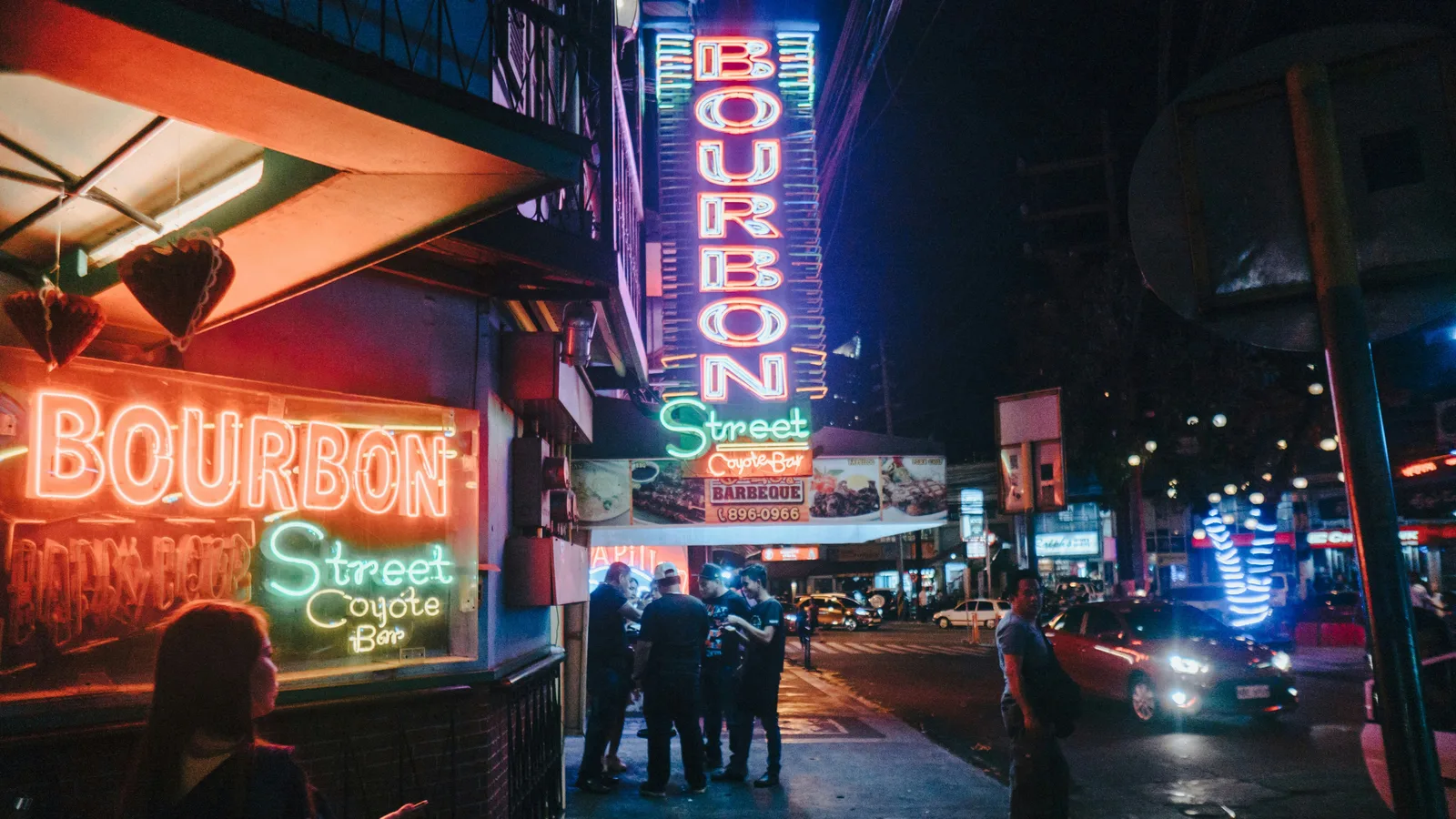 Neon signs on a sidewalk in Makati