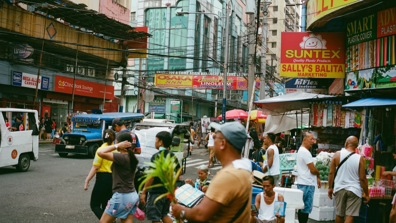 Pedestrians on a market street in the Philippines